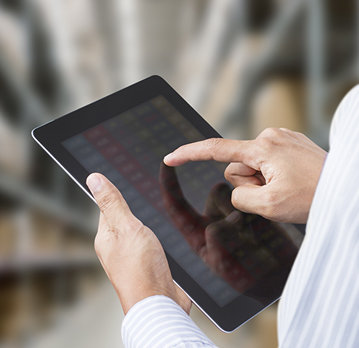 Persons hand using tablet